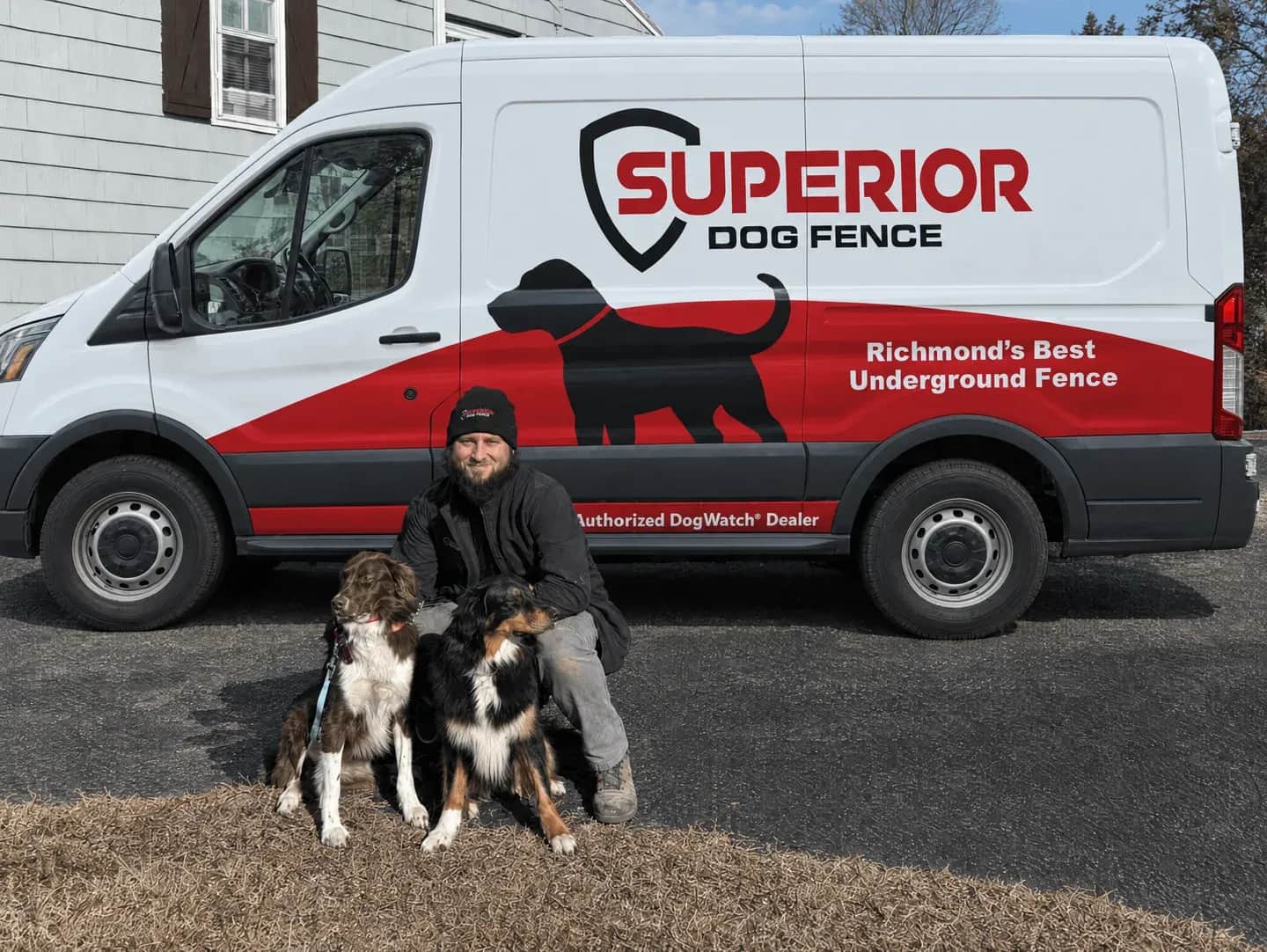 An installer with two dogs beside the Superior van.